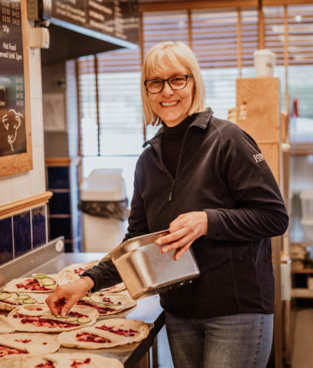 Farm shop team member making lunch wraps